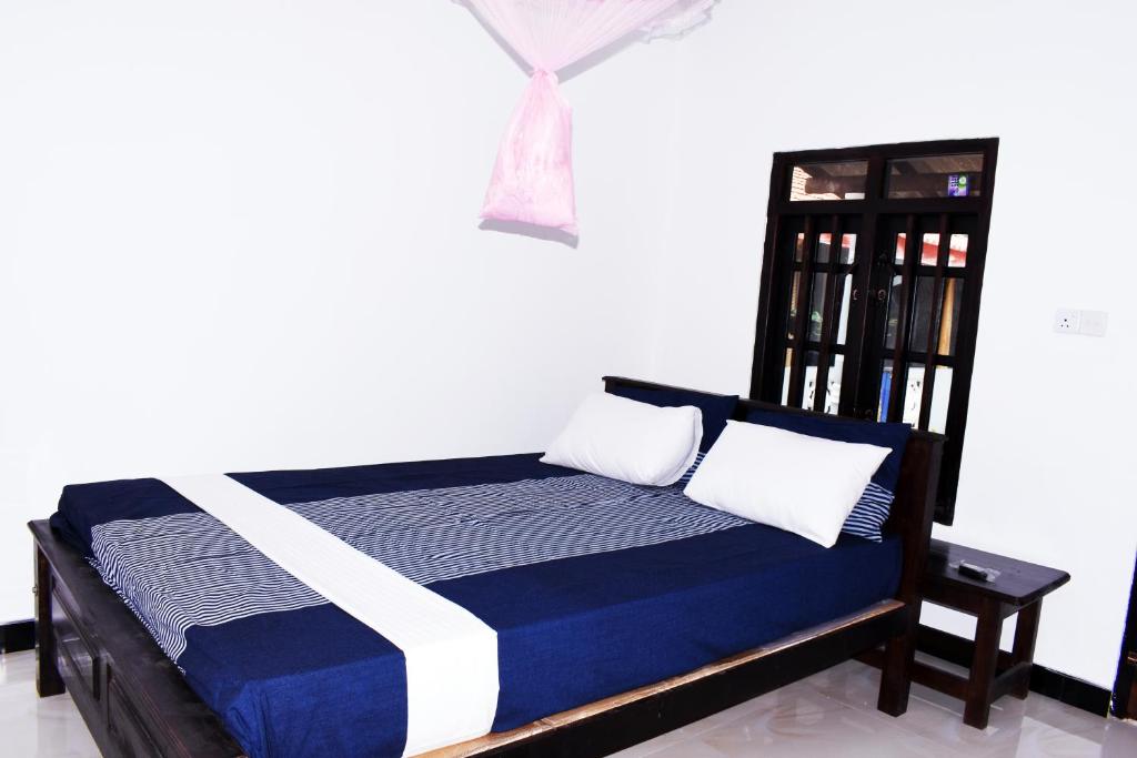 Postel nebo postele na pokoji v ubytování Suman Beach Rooms