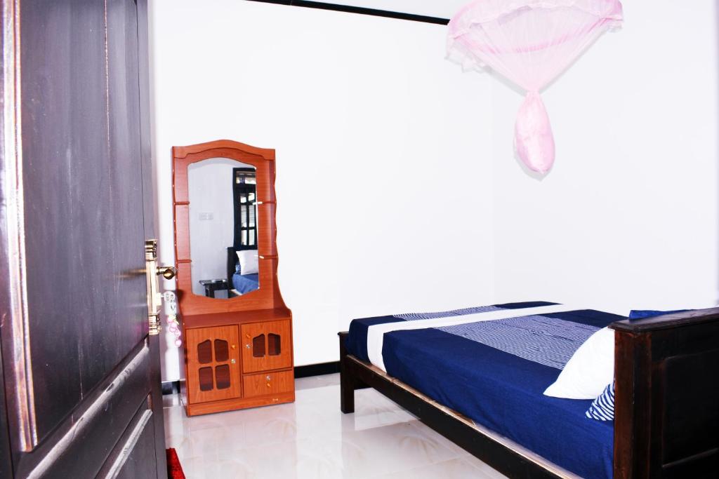 Postel nebo postele na pokoji v ubytování Suman Beach Rooms