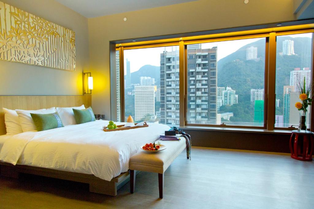 a bedroom with a large bed and a large window at Wanchai 88 in Hong Kong