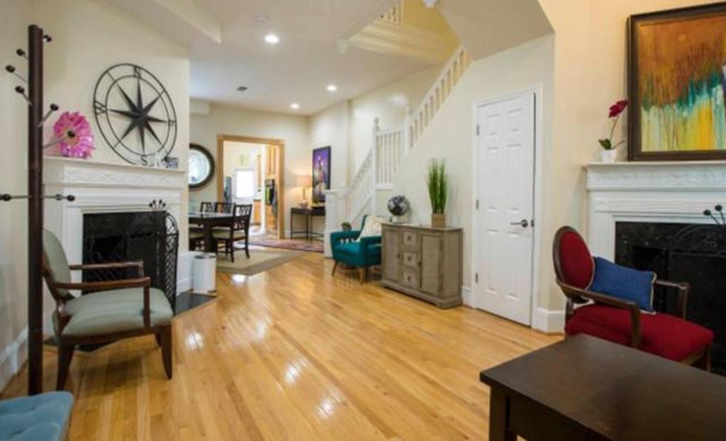 a living room with a fireplace and a living room with chairs at Convention Center/Logan Circle Large Cozy House. in Washington