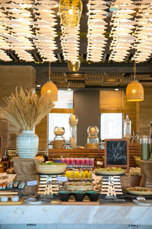 A brightly styled breakfast buffet with cereals, juices and decorative displays.