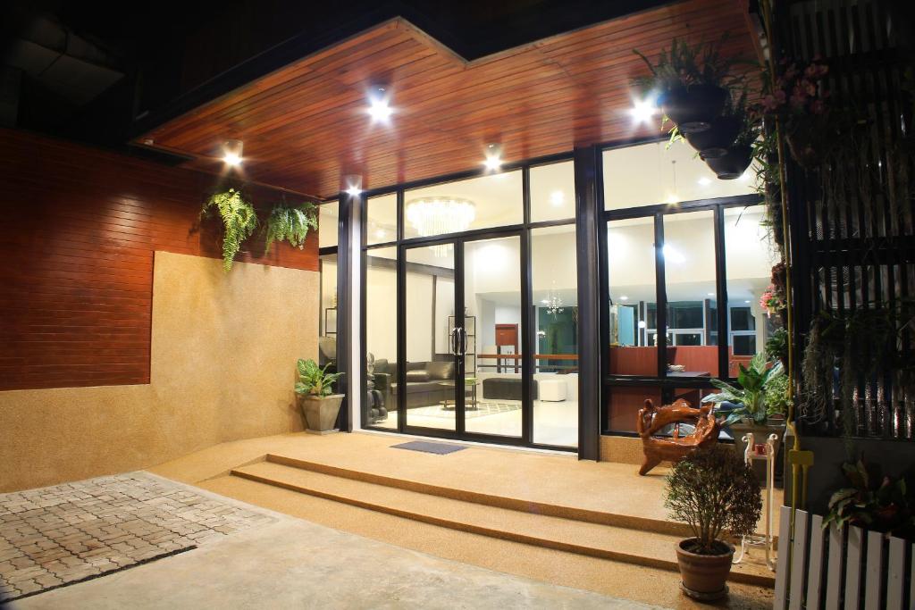 a lobby with glass doors and potted plants at S'Prima Hostel in Phitsanulok