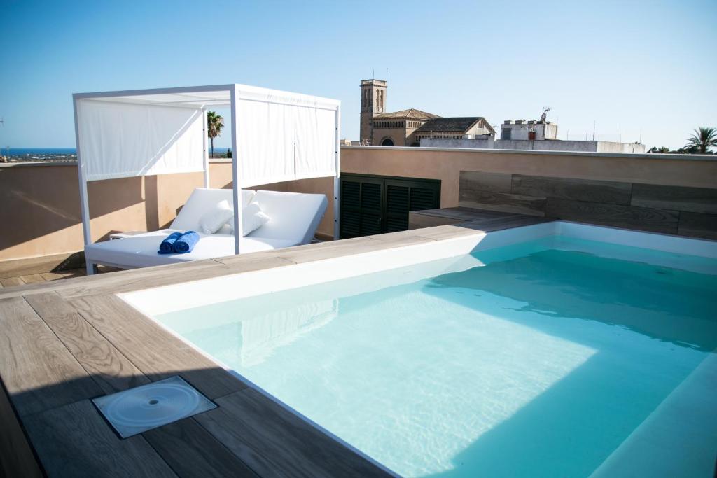 a swimming pool on the roof of a building at Boutique Hotel Petit Sant Miquel in Calonge