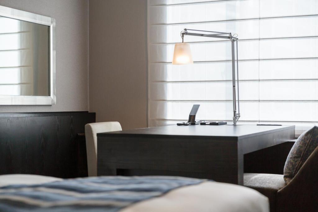 Postel nebo postele na pokoji v ubytování Hotel MYSTAYS PREMIER Dojima