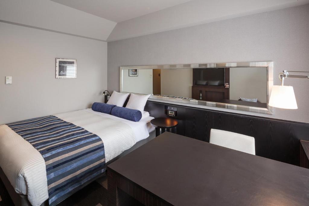 Postel nebo postele na pokoji v ubytování Hotel MYSTAYS PREMIER Dojima