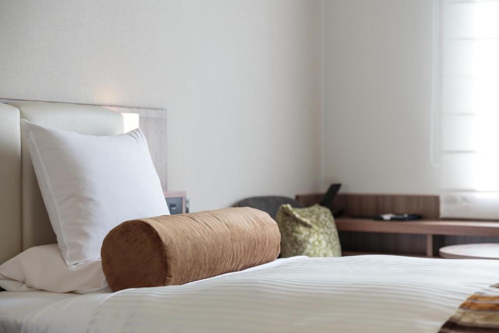 Postel nebo postele na pokoji v ubytování Hotel MYSTAYS PREMIER Dojima