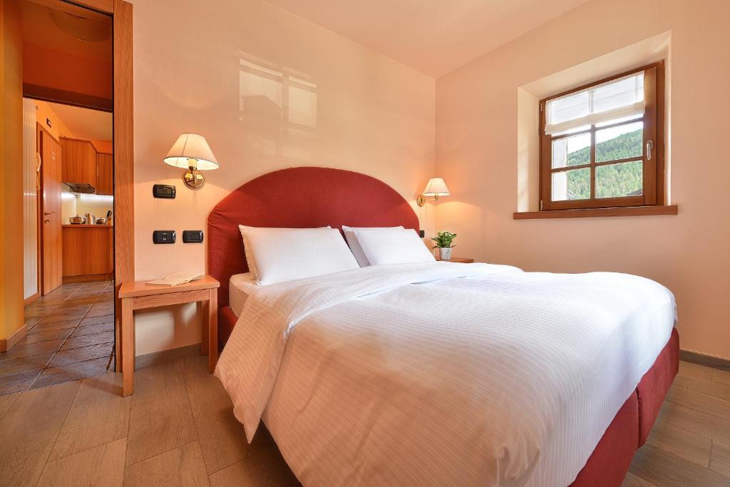 a bedroom with a large bed and a window at Chalet Matteo in Livigno