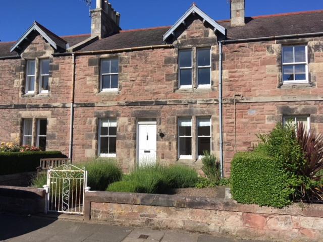 a brick house with a white door in front of it at Hopetoun Haven in Gullane