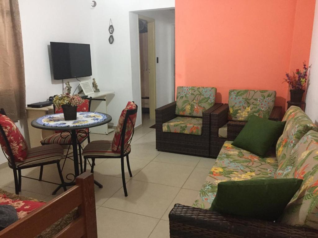 a living room with a couch and a table at Apartamento José Menino in Santos