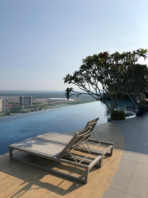 a lounge chair sitting on the edge of a building at Eclipse@Pangea Residences in Cyberjaya