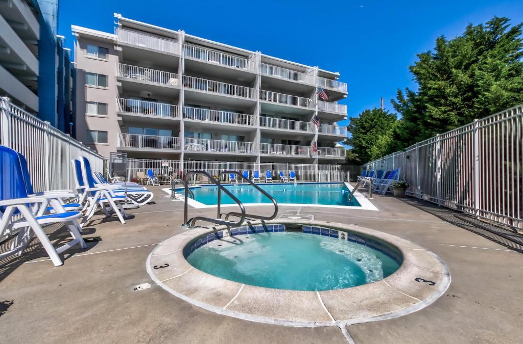 a swimming pool in front of a apartment building at Triton's Trumpet in Ocean City