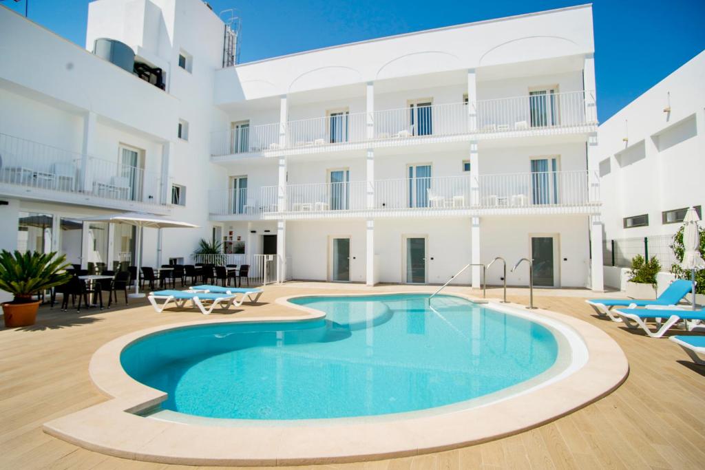 an image of a swimming pool in front of a building at INNER Hotel Rupit "Adults Only" in Cala d´Or