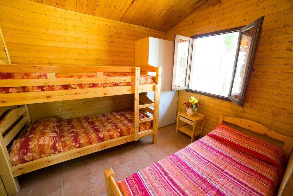 A bed or beds in a room at Camping dei Tigli