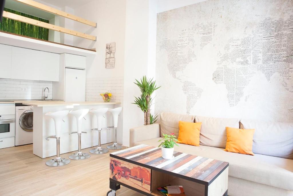 a living room with a couch and a map on the wall at NEW LOFT ATOCHA Centre in Madrid