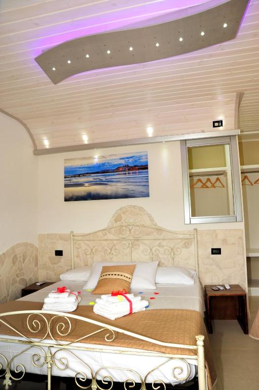 a bedroom with a large bed with a purple ceiling at Tenuta Paifer in Otranto