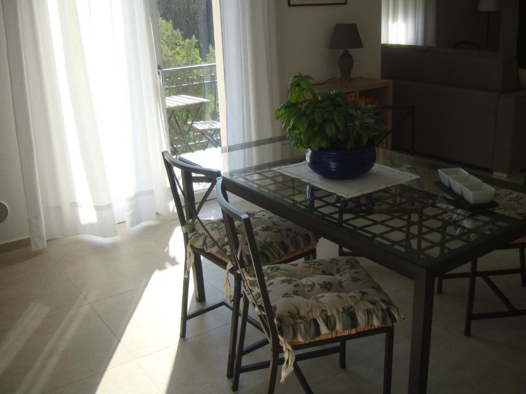 a dining room table with a potted plant on it at Serena in Cervo