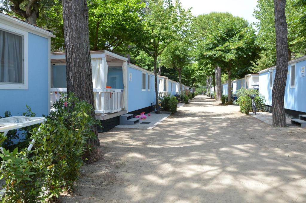 a row of blue mobile homes on a street at Topcamp in Union Lido in Cavallino-Treporti