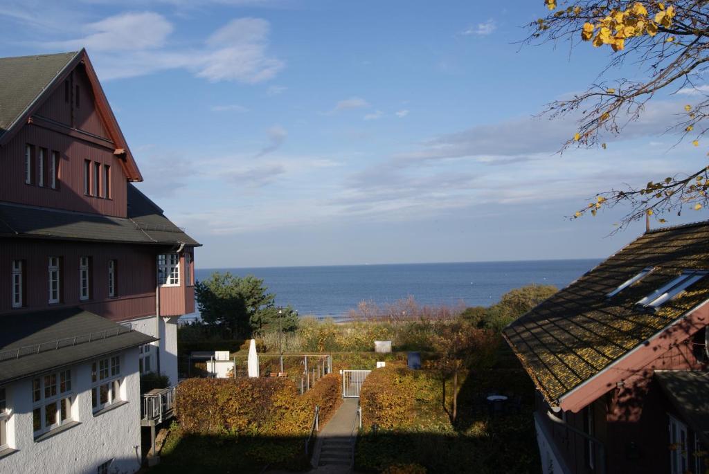 a view of the ocean from between two buildings at Seeblickstudio 2.33 im Seehof Bansin in Bansin