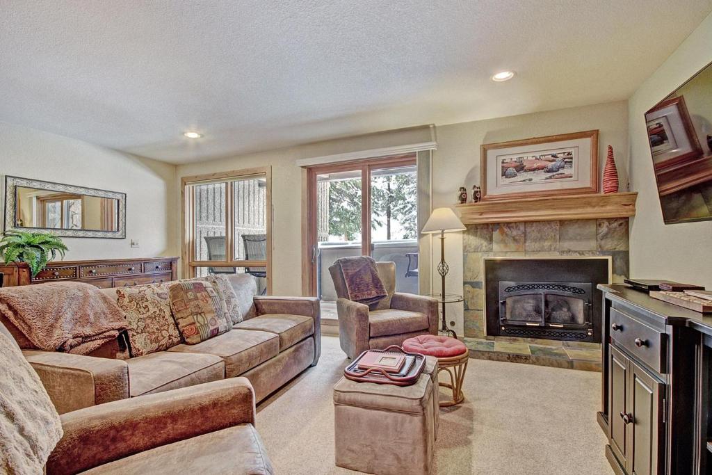 a living room with a couch and a fireplace at Cm244 Copper Mtn Inn Condo in Copper Mountain