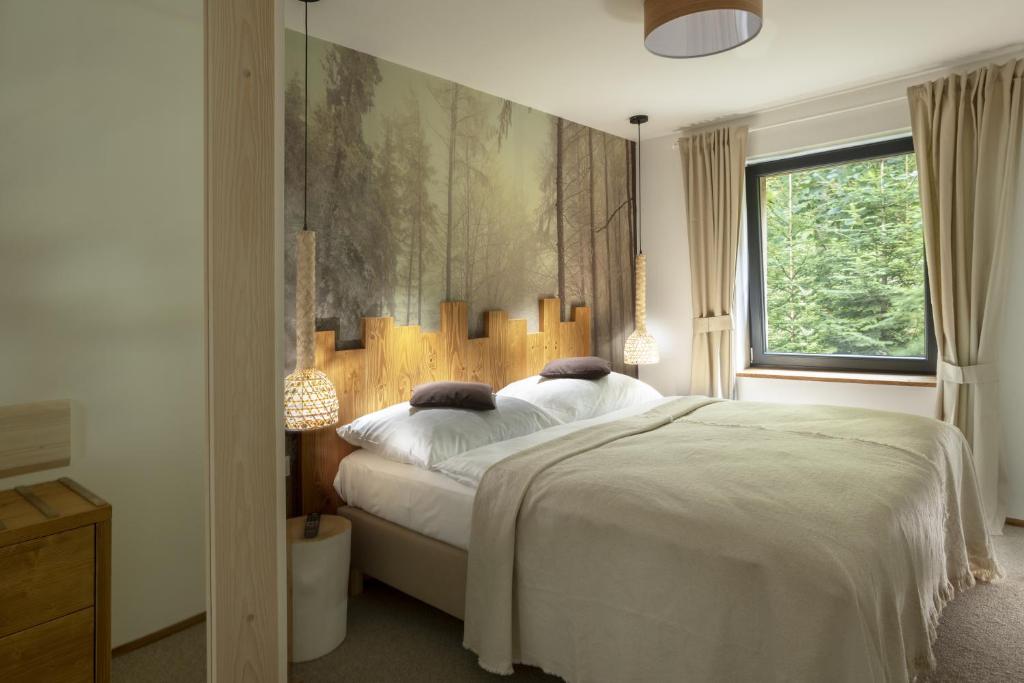 a bedroom with a large white bed and a window at Penzion Skaličí in Karolinka