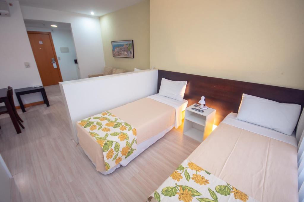 Postel nebo postele na pokoji v ubytování Iguatemi Business & Flat by Avectur