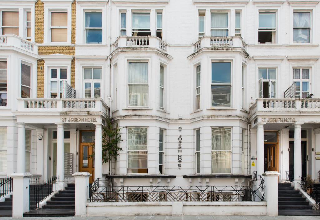 a white building with stairs in front of it at St Joseph Hotel in London