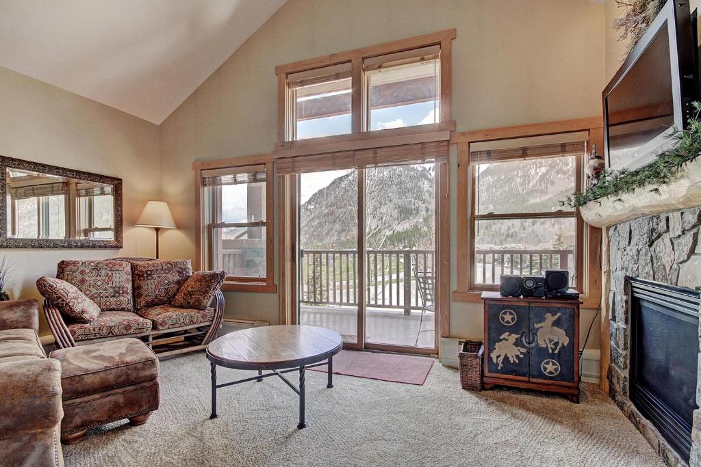 a living room with a couch and a fireplace at Cs210 Copper Springs Condo in Copper Mountain