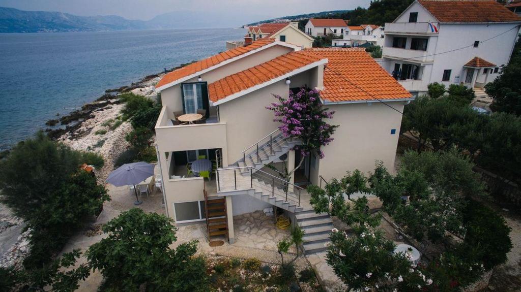 an aerial view of a house on the beach at Apartments KraljicaMira in Splitska