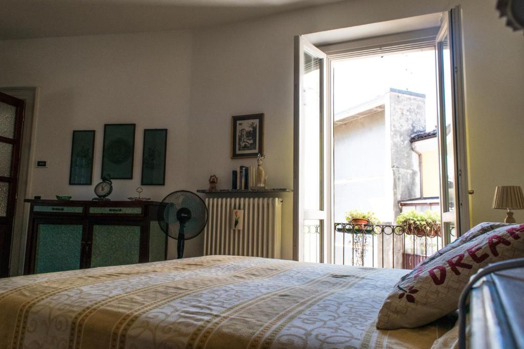 a bedroom with a bed and a large window at Casa Amata in Lecco