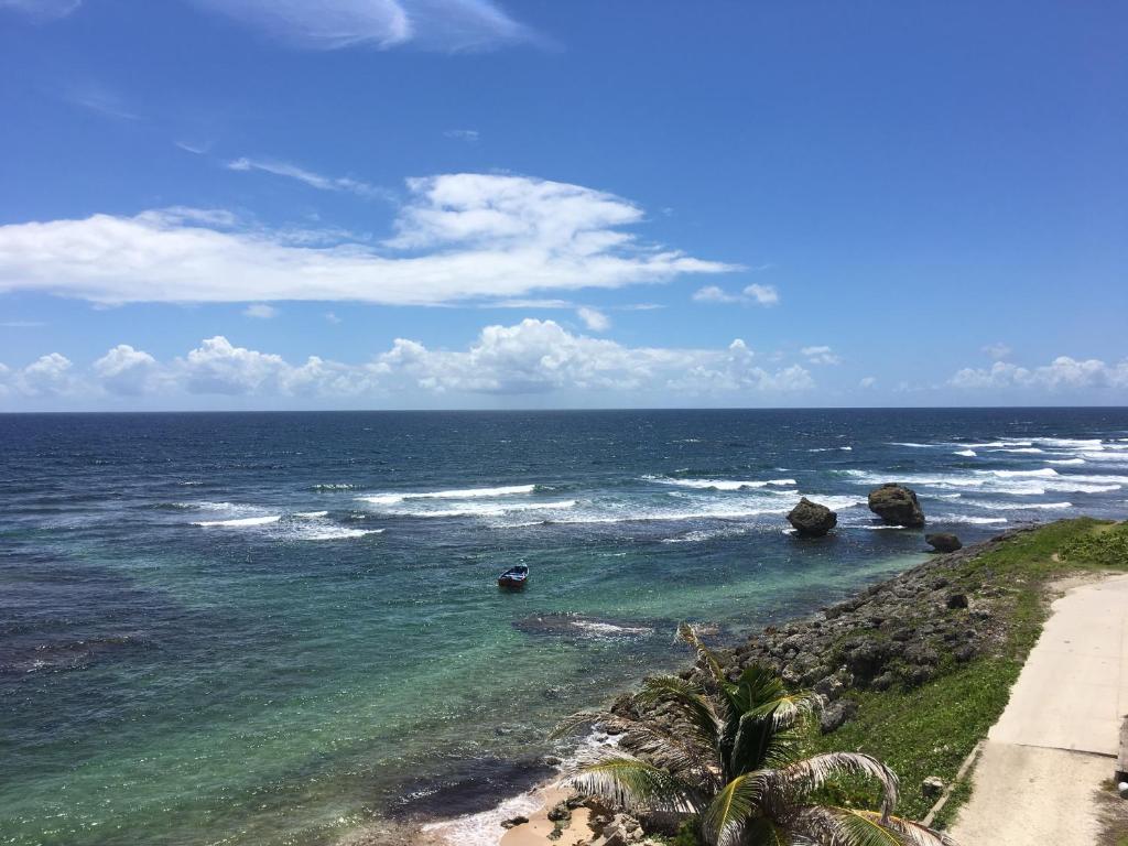 a view of the ocean with rocks and a beach at The Atlantis Historic Inn in Saint Joseph
