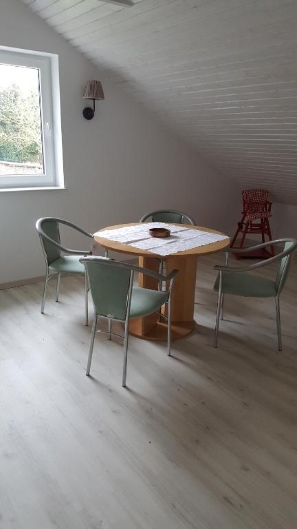 a table and chairs in a room with a window at Mecklenburger Straße 3 in Moltow