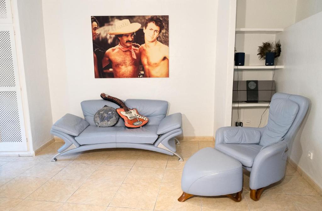 a living room with a couch and a chair at Pikes Ibiza in San Antonio