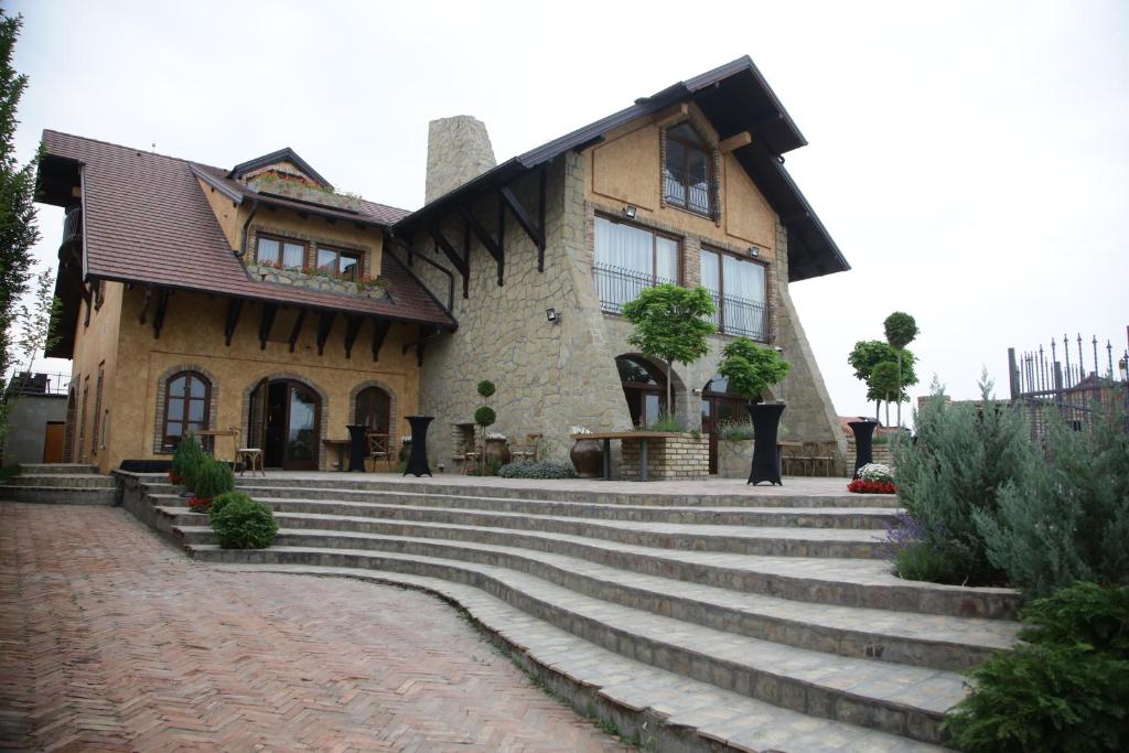 a large stone building with a staircase leading up to it at Garni Hotel Chicha - Winery ŠKRBIĆ in Belgrade