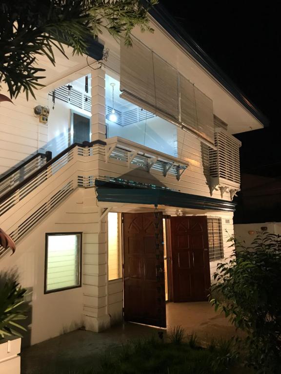 a house with two doors and a balcony at night at Casa Arrieta Hostel in Dumaguete