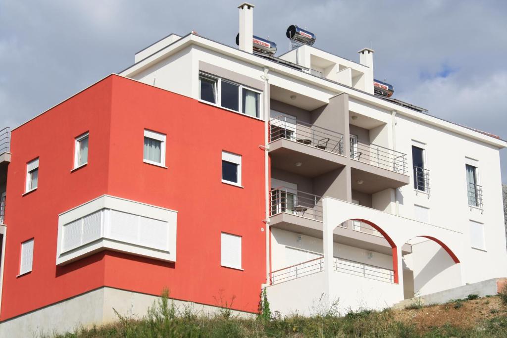a red and white building on a hill at Luxury Apartments Villa Lenka in Podstrana