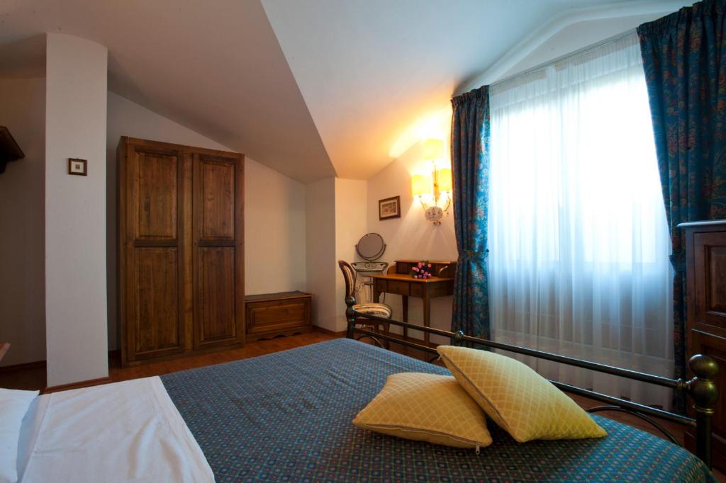 Postel nebo postele na pokoji v ubytování Albergo La Lanterna