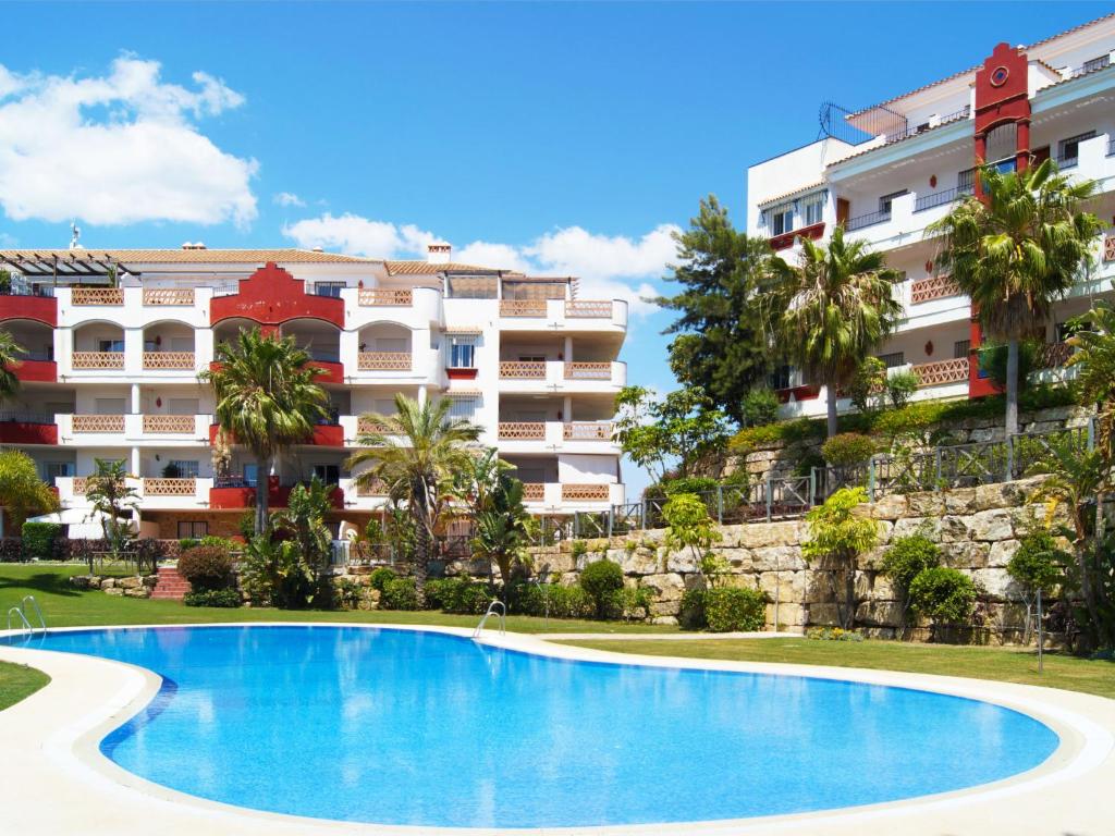 a swimming pool in front of a building at Apartment Island of Riviera Golf by Interhome in Sitio de Calahonda