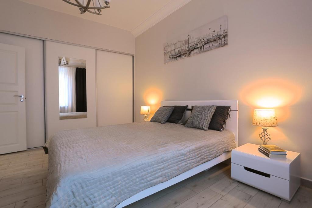 Postel nebo postele na pokoji v ubytování Central Apartament II