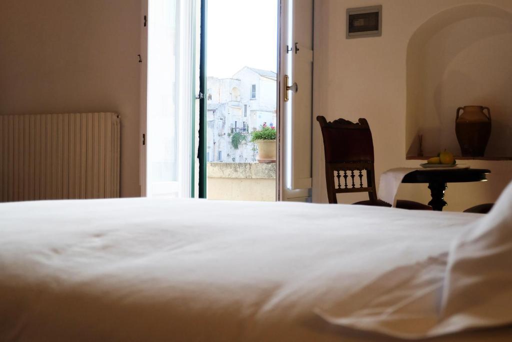 Postel nebo postele na pokoji v ubytování L' Abbraccio dei Sassi