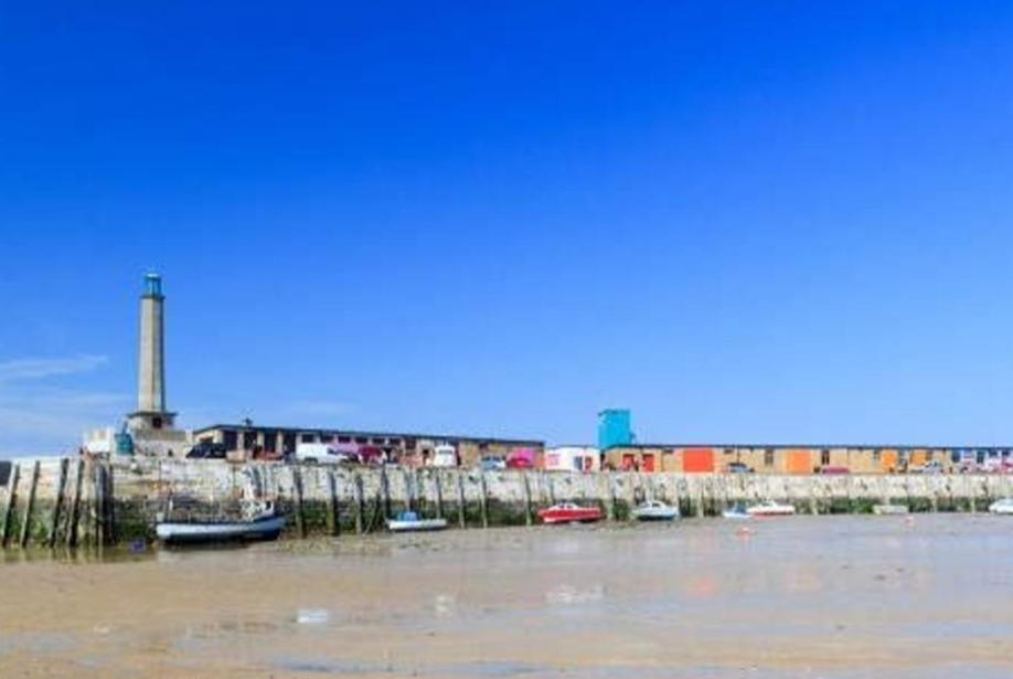 a group of boats in the water near a harbor at Kent Getaways in Westgate-on-Sea