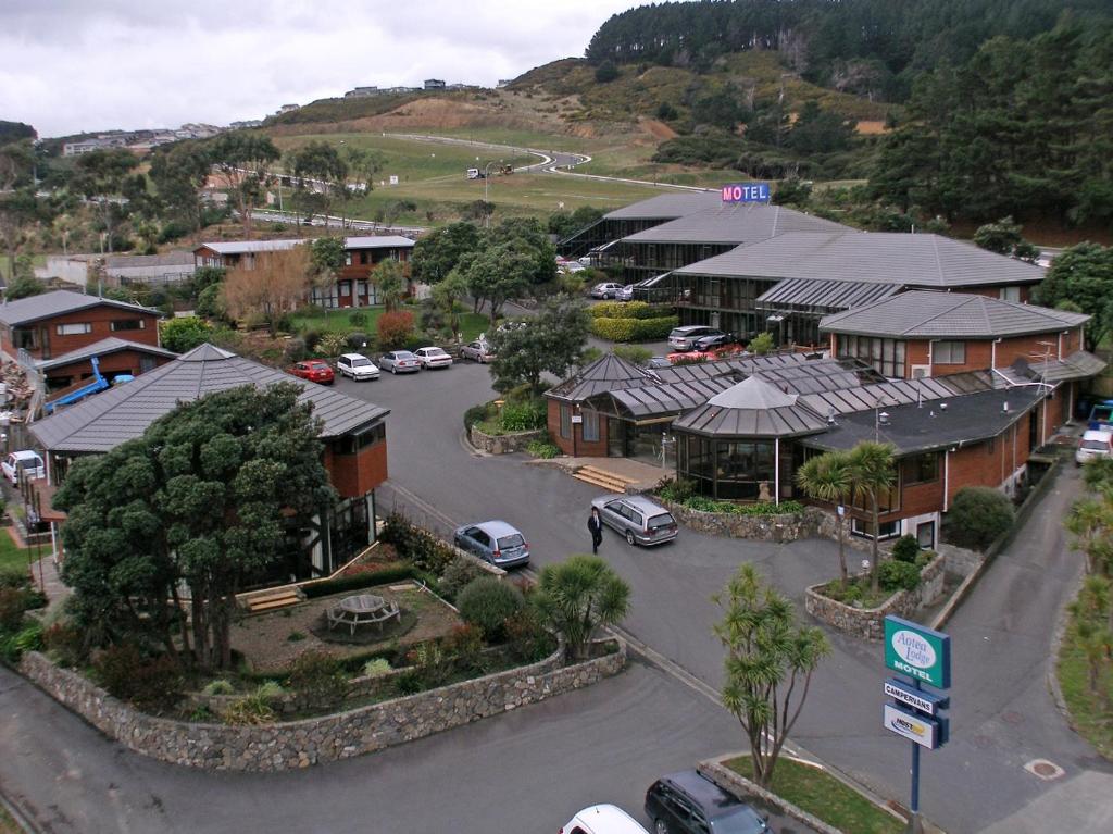 an aerial view of a town with cars parked in a parking lot at Aotea Lodge Porirua in Porirua