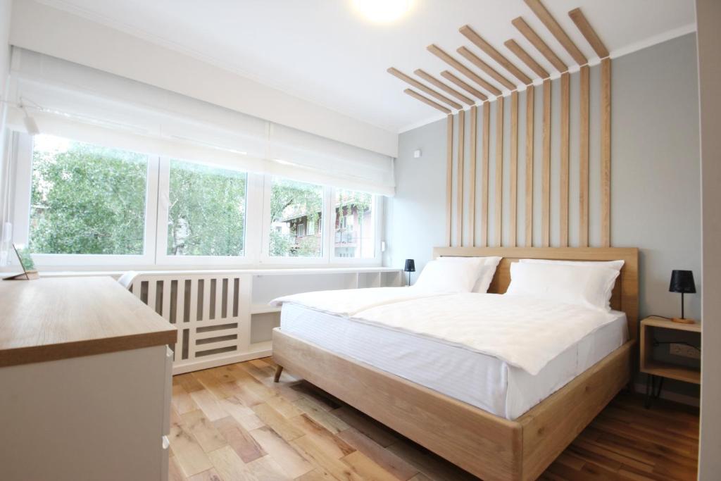 מיטה או מיטות בחדר ב-Sunshine Apartment