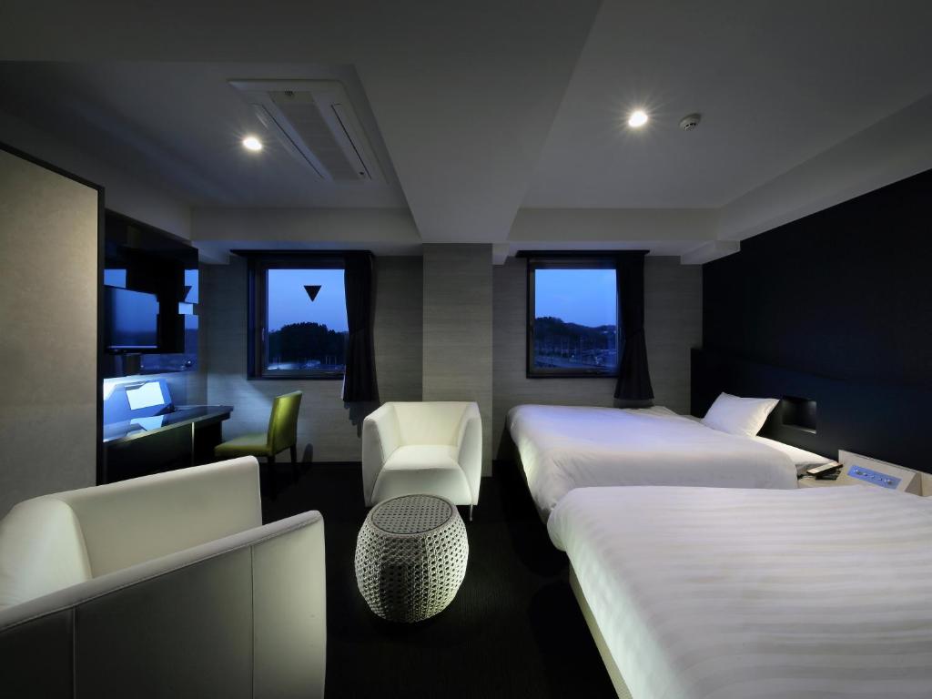 Postel nebo postele na pokoji v ubytování Venezian Hotel Shiroishi Zao