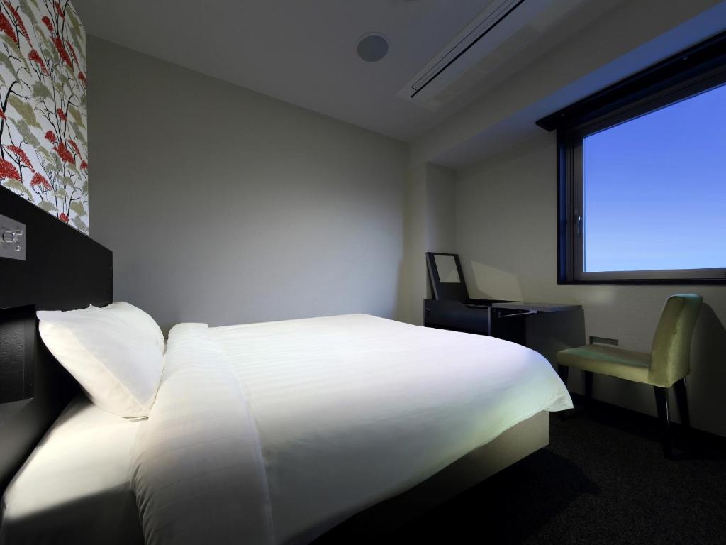 Postel nebo postele na pokoji v ubytování Venezian Hotel Shiroishi Zao