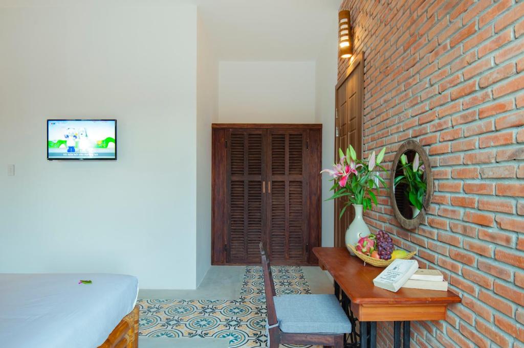 Postel nebo postele na pokoji v ubytování Hoi An Rustic Villa