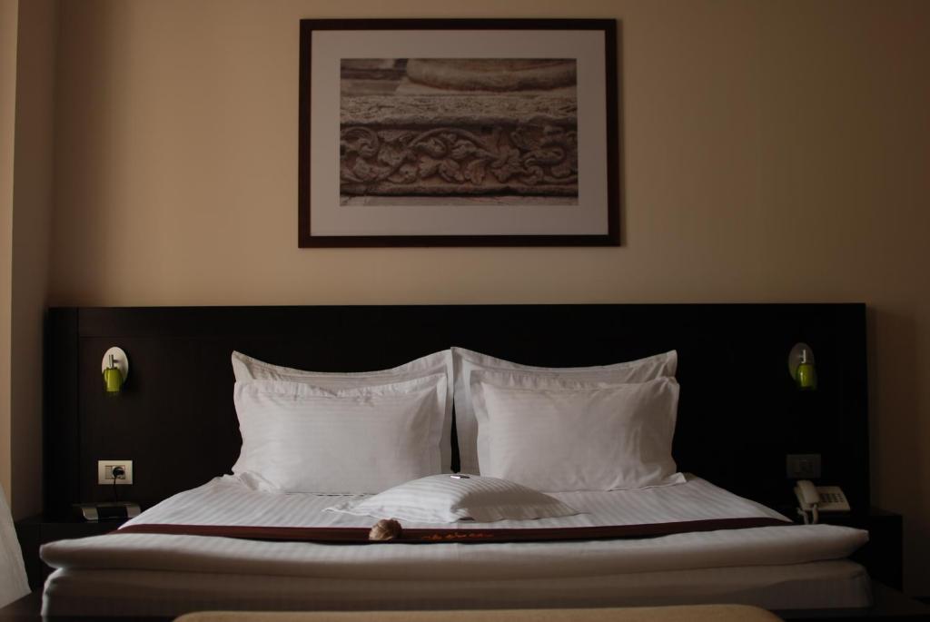 Postel nebo postele na pokoji v ubytování Hotel Cherica