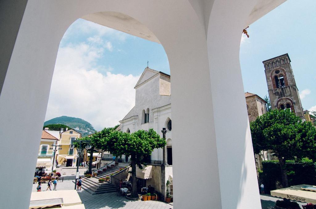 a view of a church from an arch in a city at Ravello In in Ravello