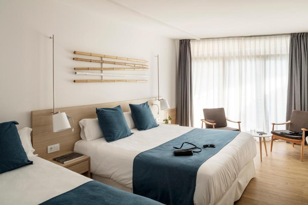 Postel nebo postele na pokoji v ubytování AQUA Hotel Onabrava & Spa 4*Sup