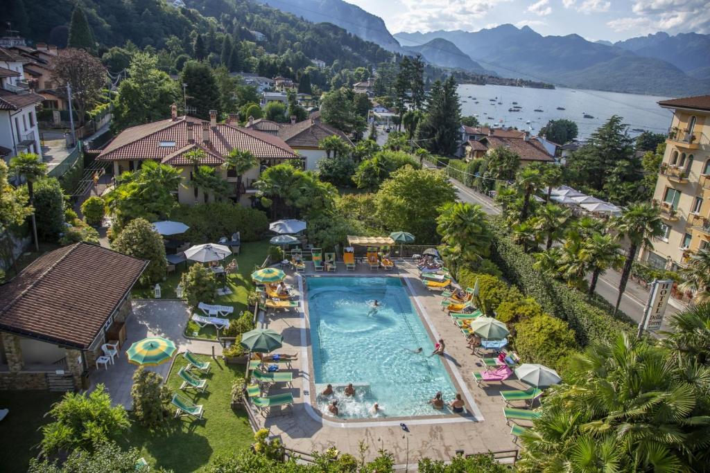 an overhead view of a resort swimming pool with umbrellas at Hotel Della Torre in Stresa