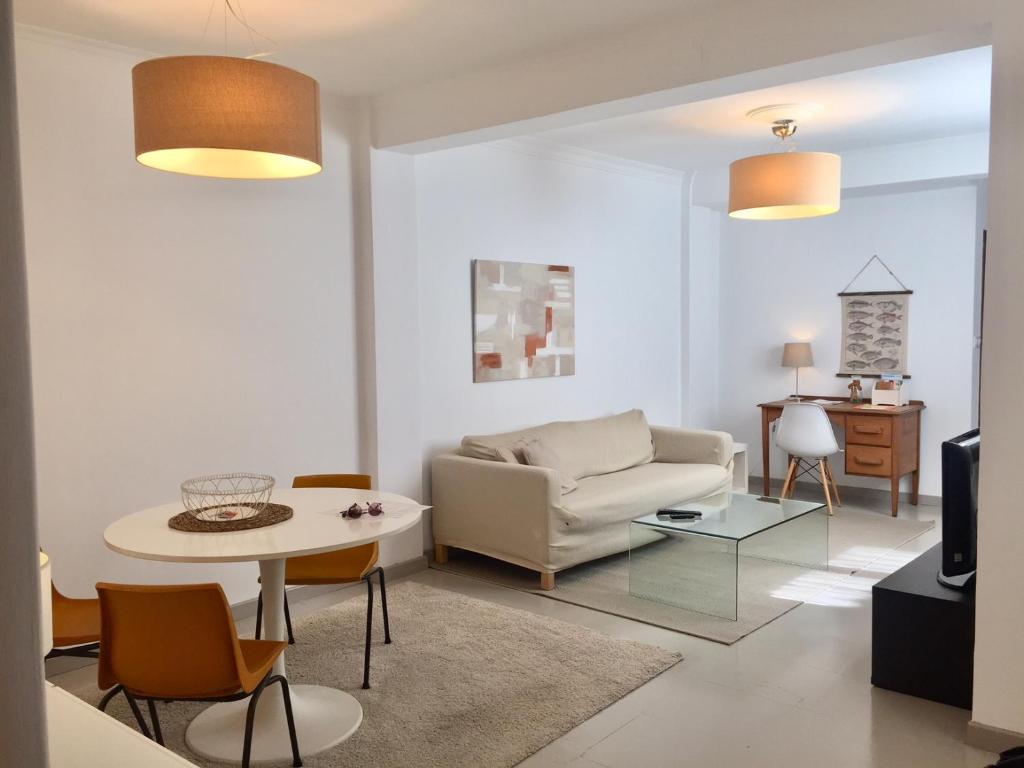 a living room with a couch and a table at Apartamento turístico en pleno centro de Ferrol in Ferrol